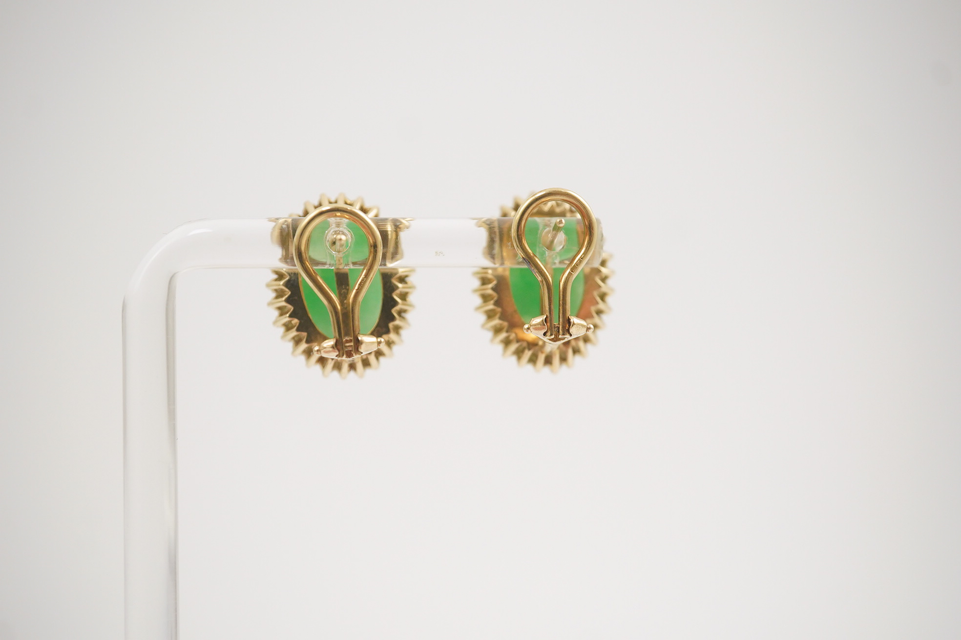 A pair of mid 20th century gold, cabochon jade and diamond cluster set oval earrings